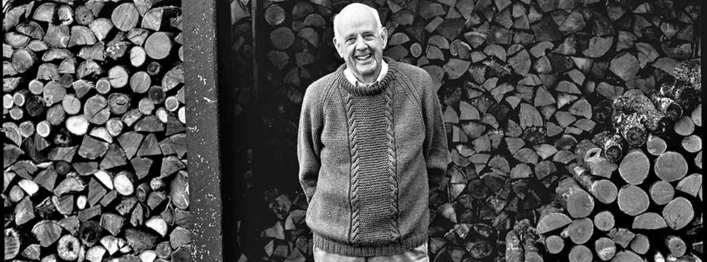 A black and white portrait of Wendell Berry.
