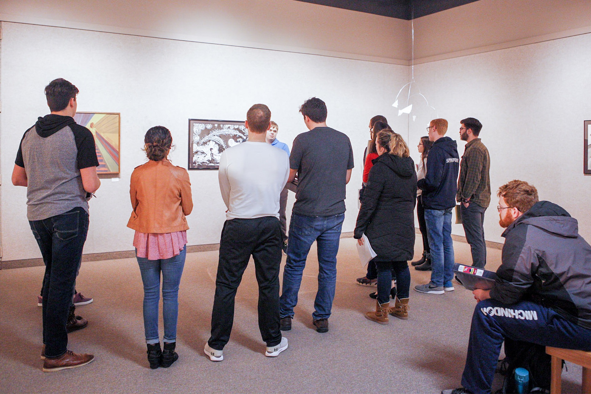 Students reviewing artwork in Art Gallery