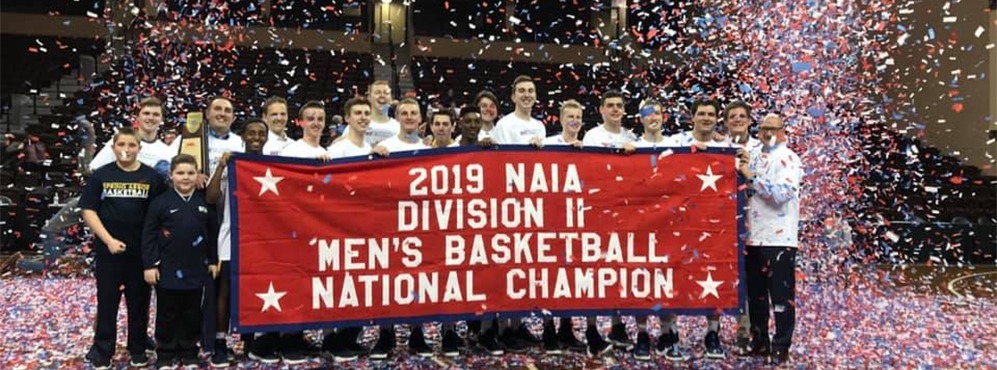 Group photo of men's basketball team after NAIA national championship win