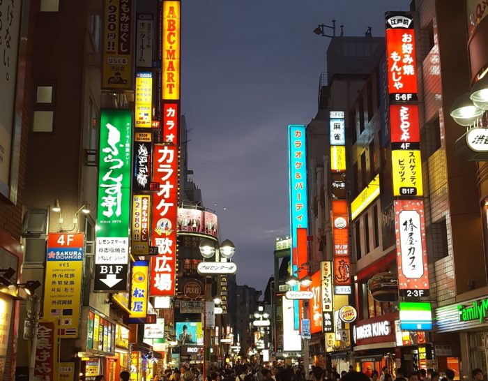 Busy evening Tokyo street with neon multi-colored signs