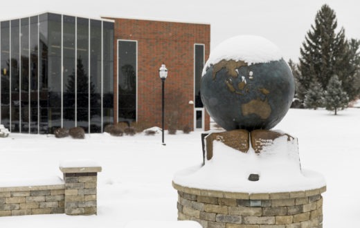 Snow covering the globe outside of the Kresge Student Center