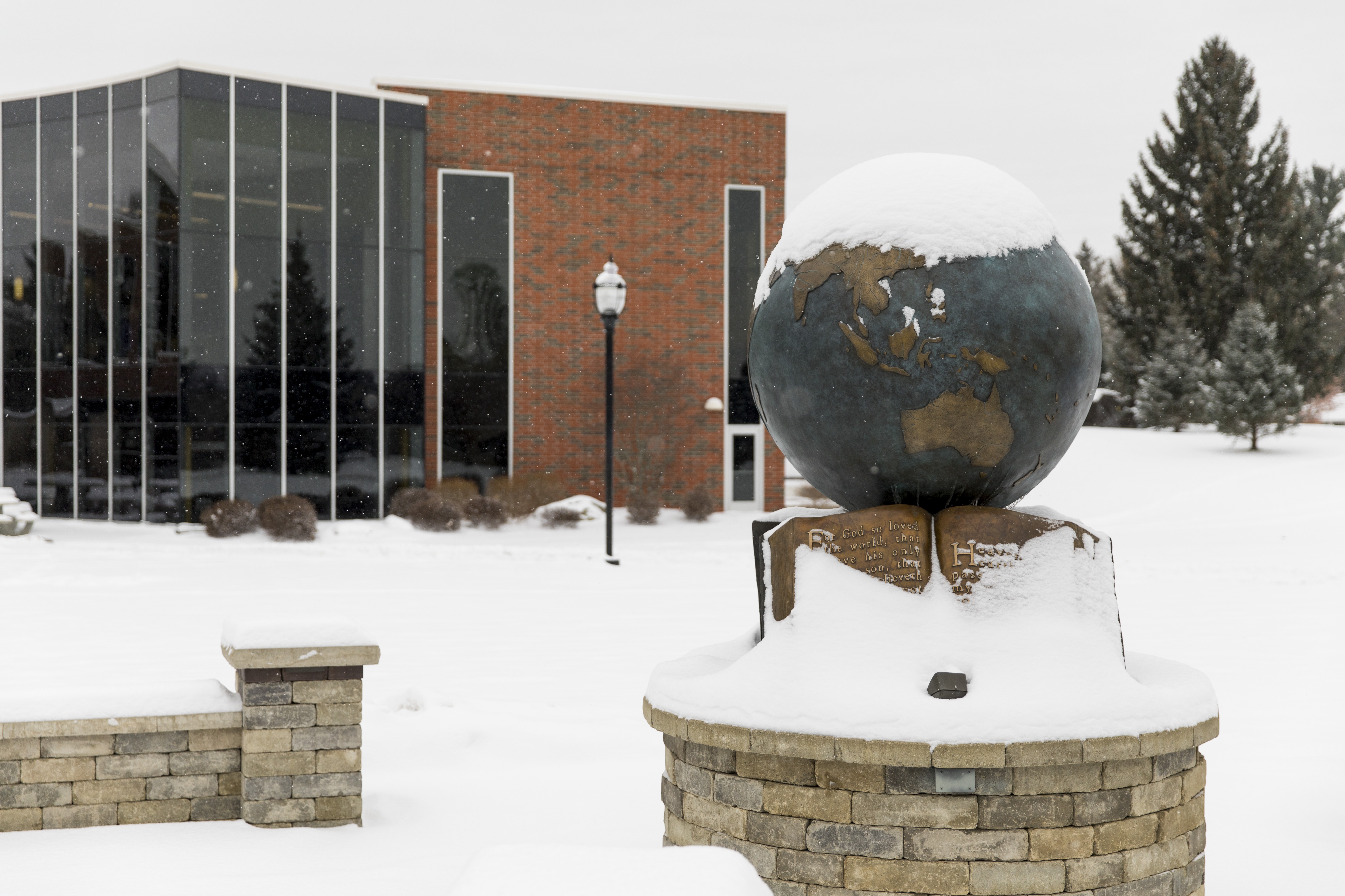 Snow covering the globe outside of the Kresge Student Center