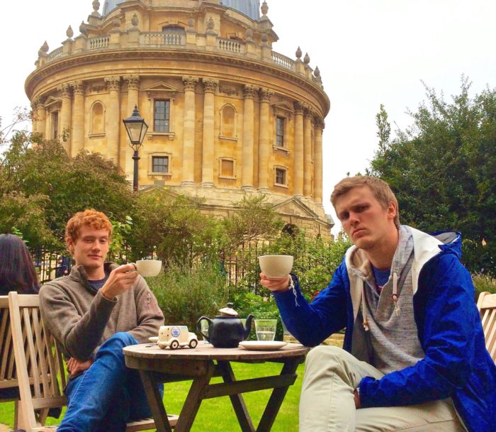 Two male Spring Arbor University students sharing tea outdoors in front of the Bodleian Library at the University of Oxford