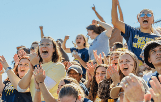students celebrating a homecoming soccer game
