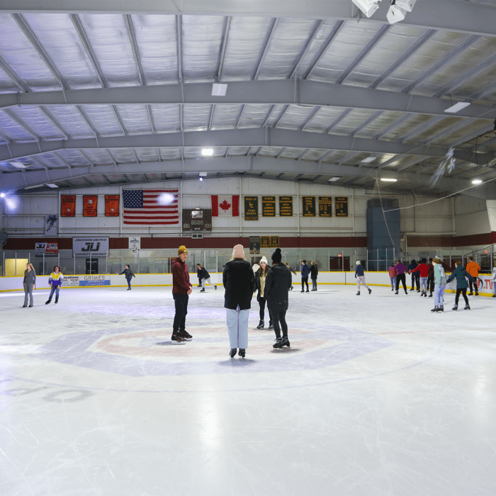 Ice rink where people are skating a having fun!
