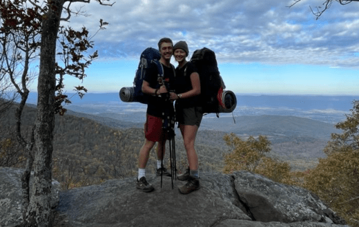 Two students with backpacking gear on standing on an Appalachian Mountain.